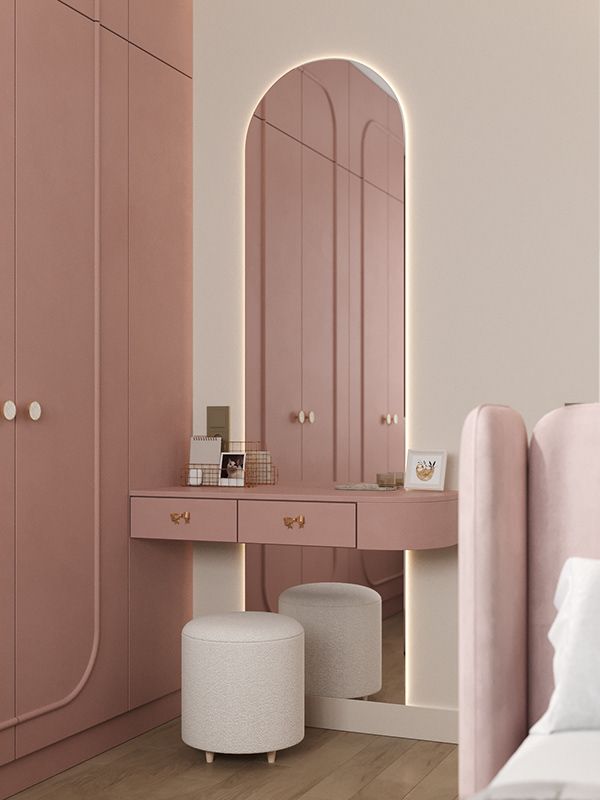 Compact apartment bedroom vanity with an elegant mirror, upholstered stool, and decorative accessories.