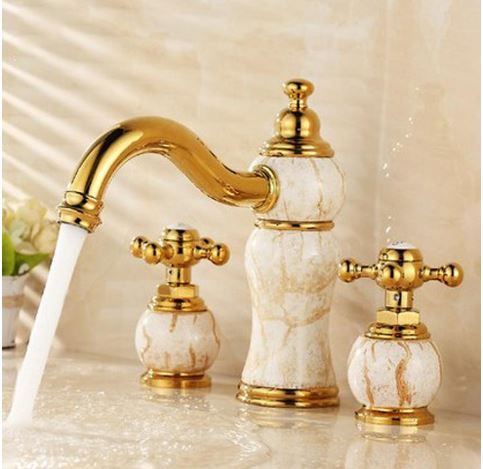 Modern kitchen with a brushed gold pull-down faucet and elegant  sink.